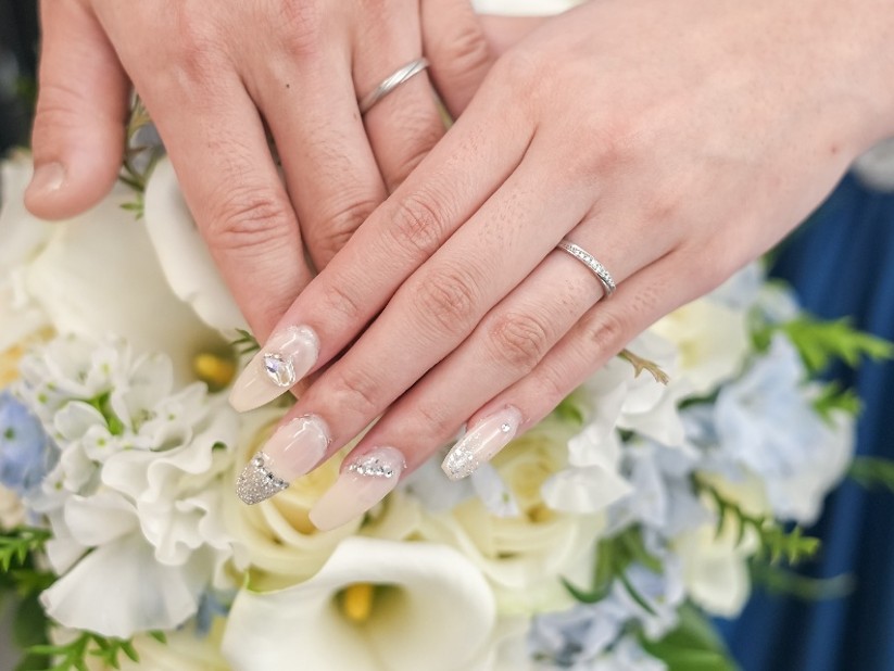 名古屋市の結婚式場ビアンカーラヒルサイドテラスで撮影した新郎新婦の手元。上品なブライダルネイルと結婚指輪、ウェディングブーケが美しい特別な一枚。